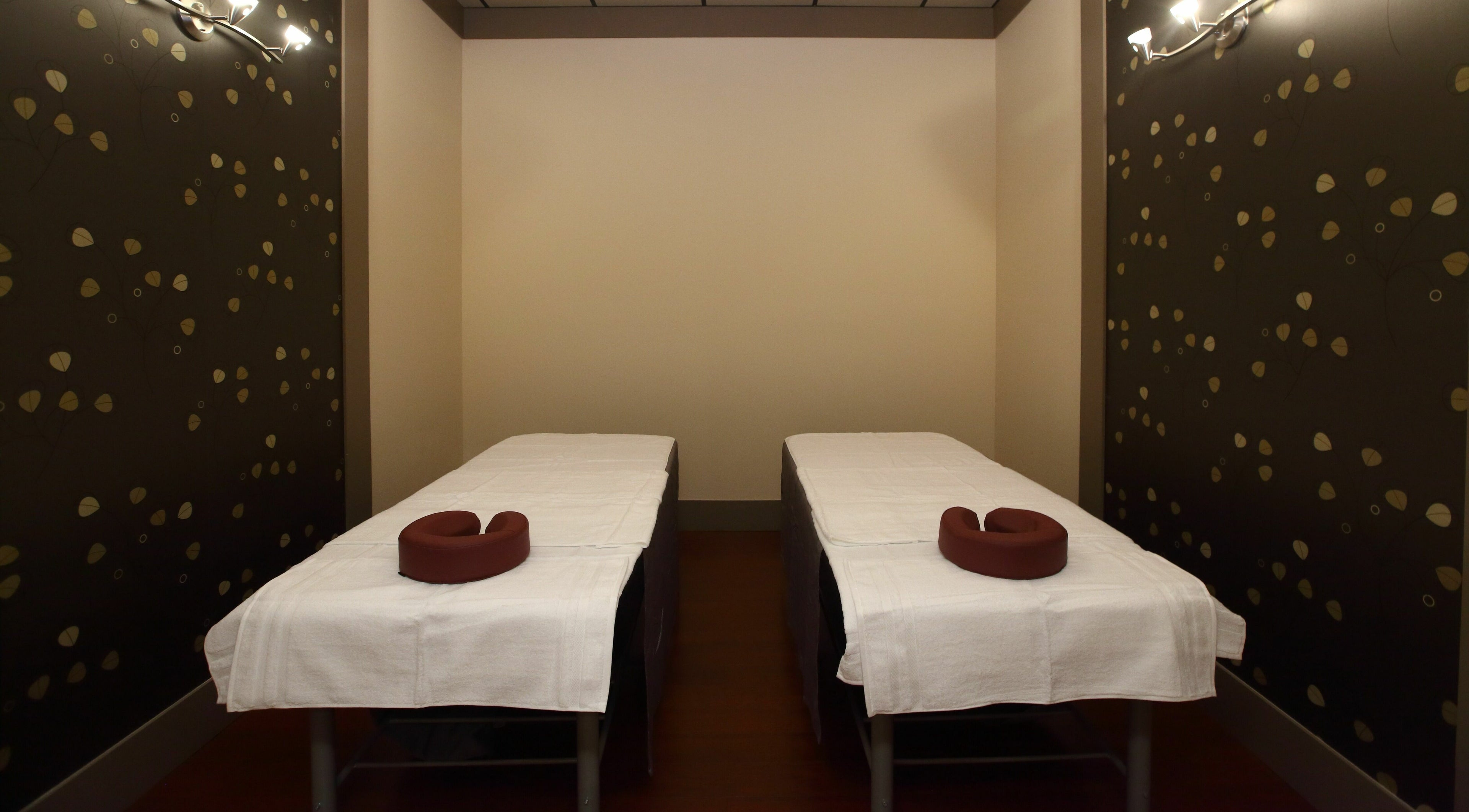 Cozy twin massage tables at Aria Spa, Butler, New Jersey, US offer serene relaxation in stylish ambiance.