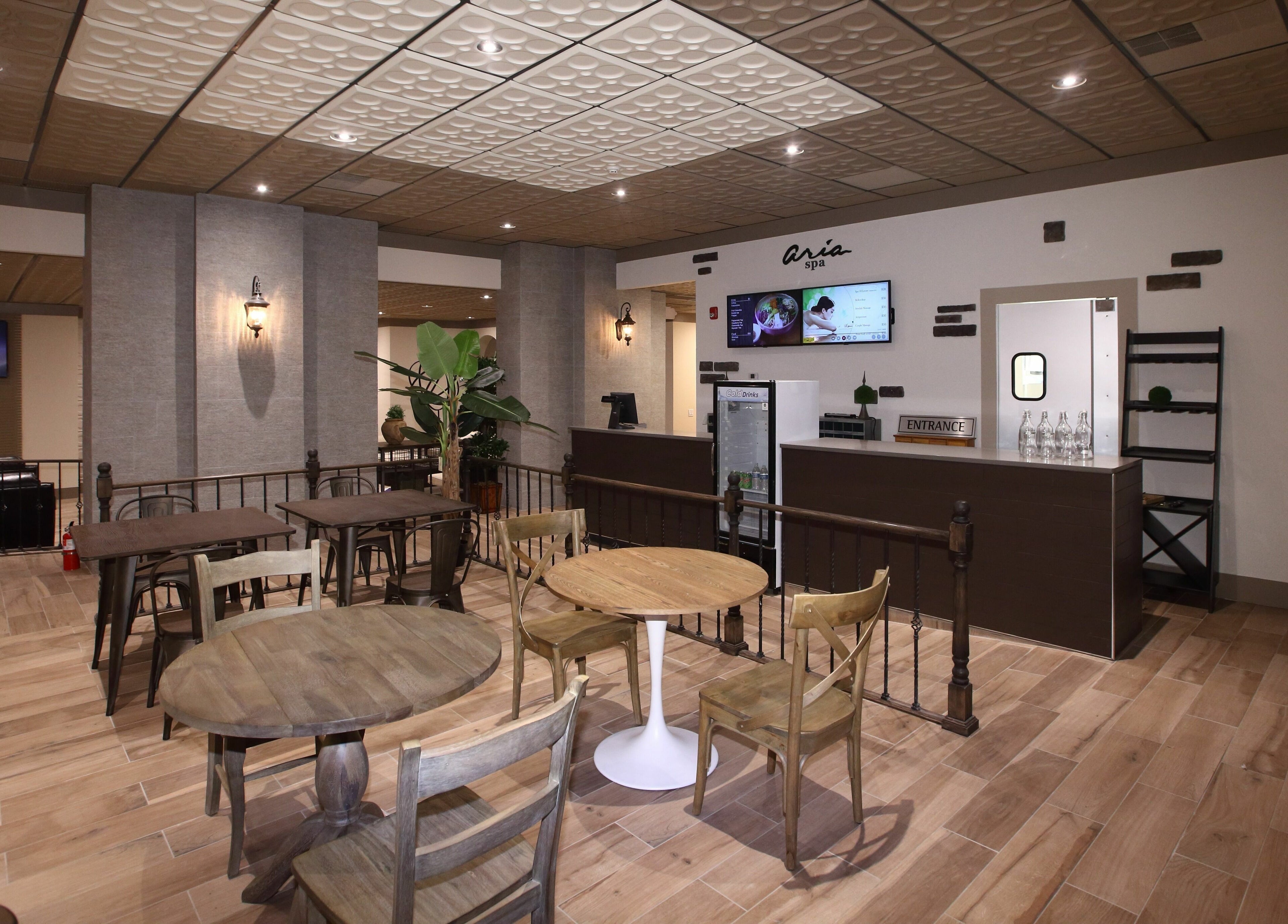 Aria Spa's welcoming lounge area in Butler, New Jersey, US, featuring elegant wooden decor and seating.