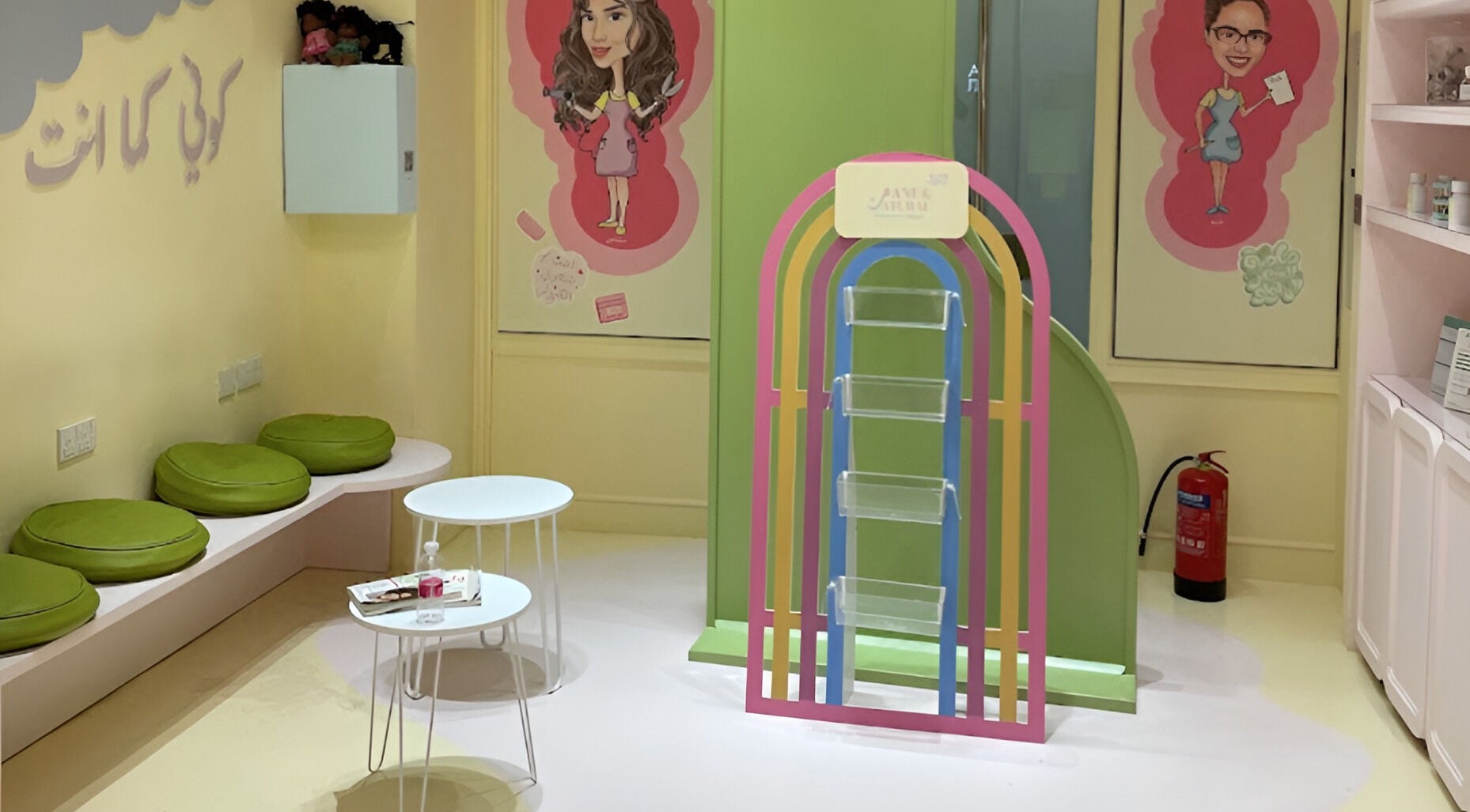 ManeandNatural | كيرلي بوتيك - Riyadh Branch seating area with green cushions and colorful decor. Riyadh, SA.