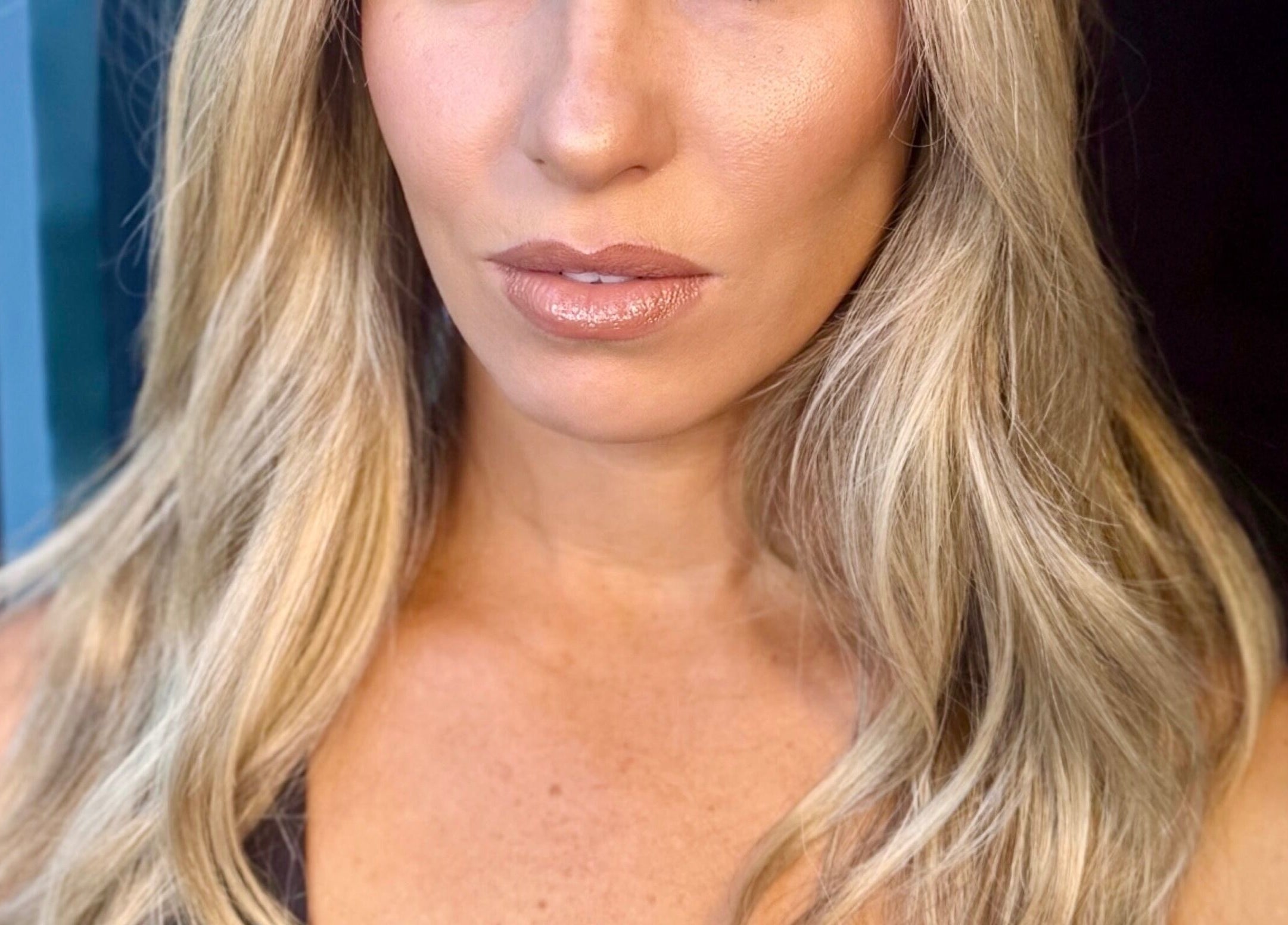 Woman with glowing skin and blonde hair at Pink Mantis Beauty, Nashville, Tennessee, US.