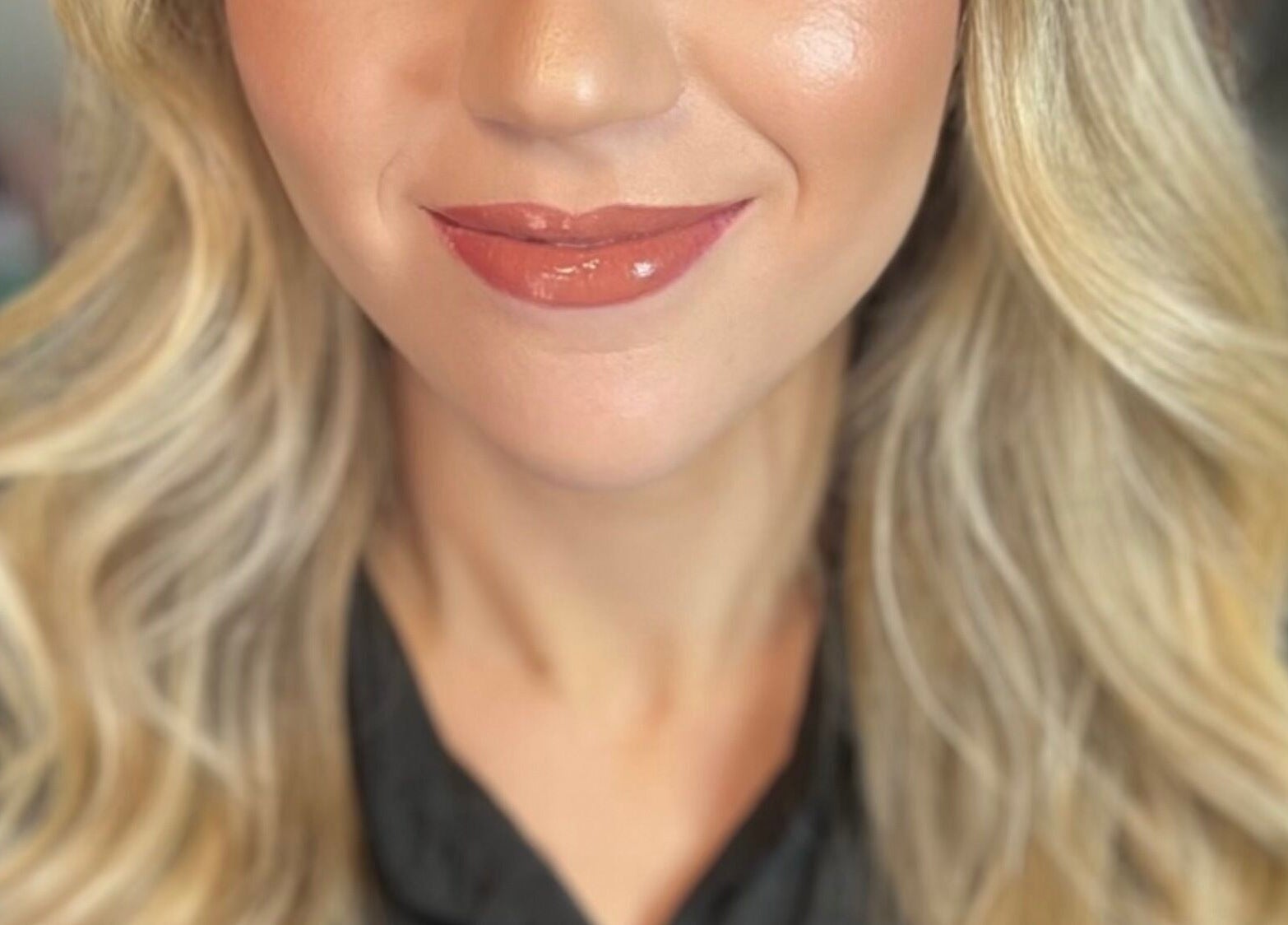 Blonde woman with radiant smile and makeup at Pink Mantis Beauty, Nashville, Tennessee, US.