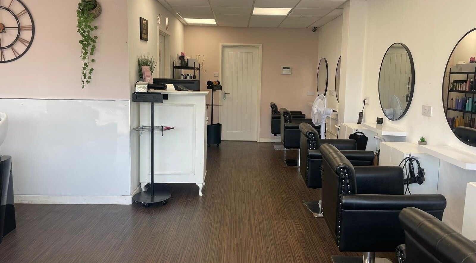 Bright and chic interior of Bliss Hair & Beauty Lounge Holland-on-Sea, England, GB with stylish leather chairs.