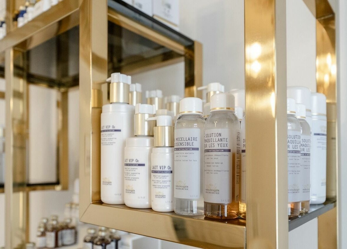 Product display at Ambassade Biologique Recherche Zürich in Zürich, CH, with gold shelves and skincare items.