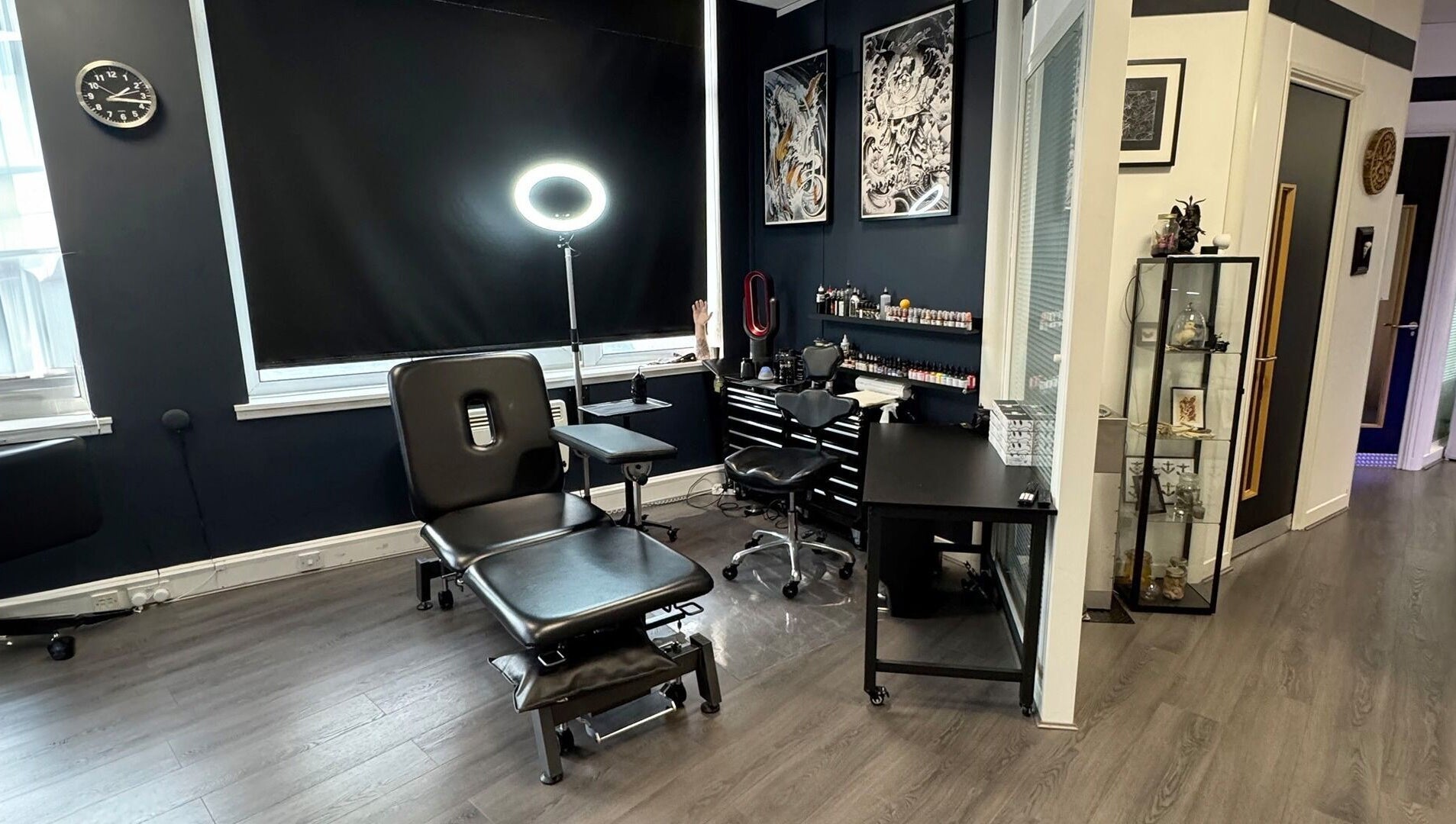 Creative interior of Valhalla Tattoo Studio, Kilmarnock, Scotland, GB featuring tattoo workstations and art.