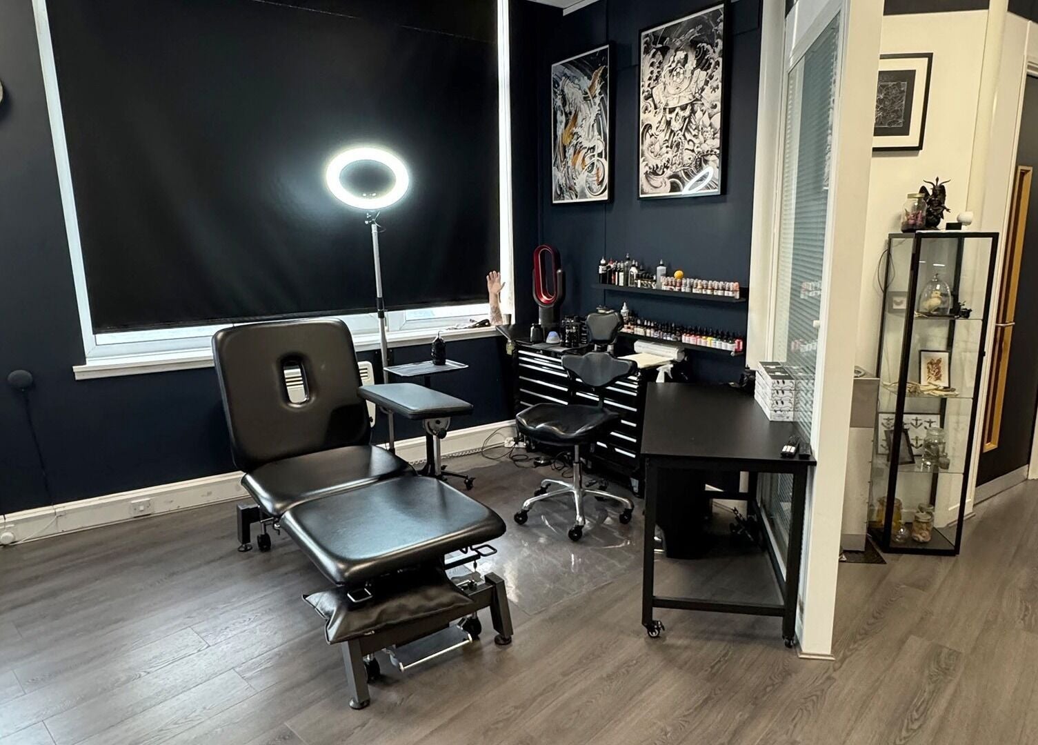 Creative interior of Valhalla Tattoo Studio, Kilmarnock, Scotland, GB featuring tattoo workstations and art.