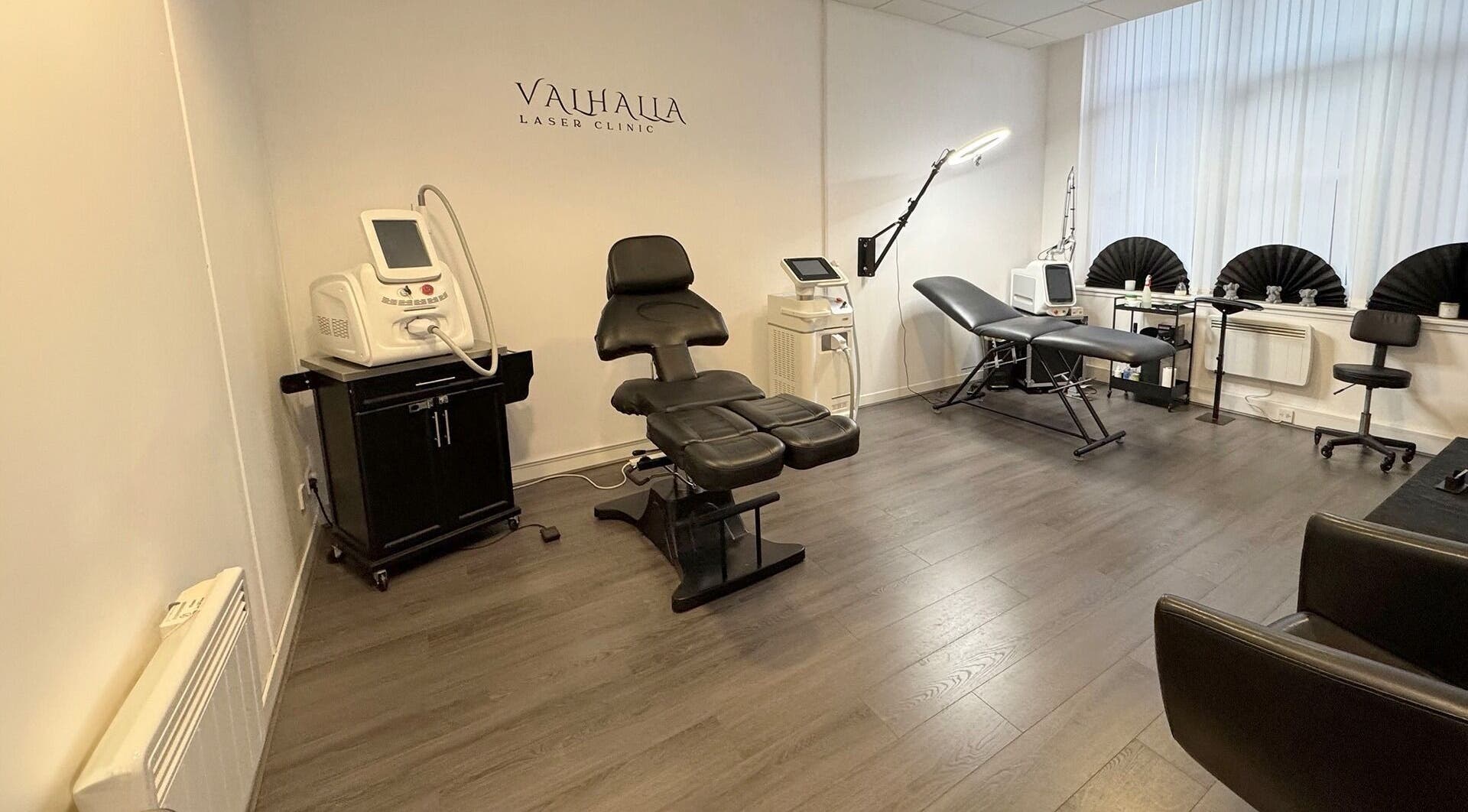 Modern interior of Valhalla Tattoo Studio in Kilmarnock, Scotland, GB, showcasing sleek furniture and equipment.