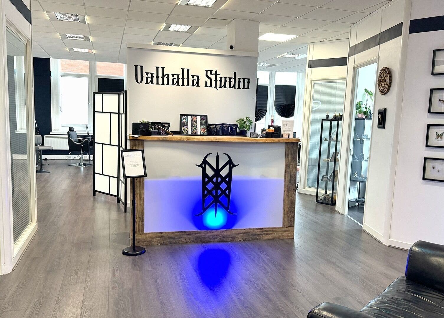 Welcoming reception at Valhalla Tattoo Studio, Kilmarnock, Scotland, GB with modern decor and vibrant lighting.