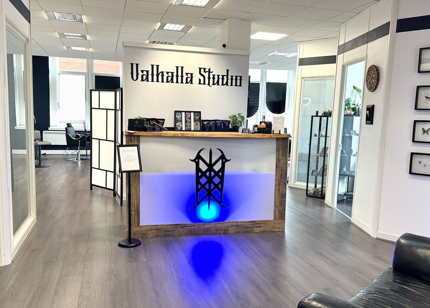 Welcoming reception at Valhalla Tattoo Studio, Kilmarnock, Scotland, GB with modern decor and vibrant lighting.