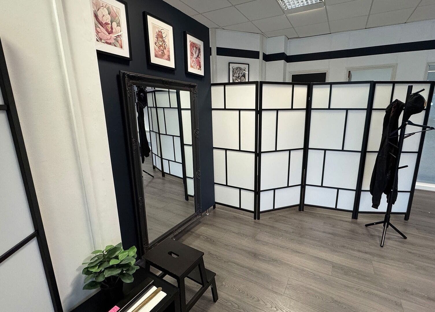 Interior view of Valhalla Tattoo Studio in Kilmarnock, Scotland, GB with elegant decor and mirror.