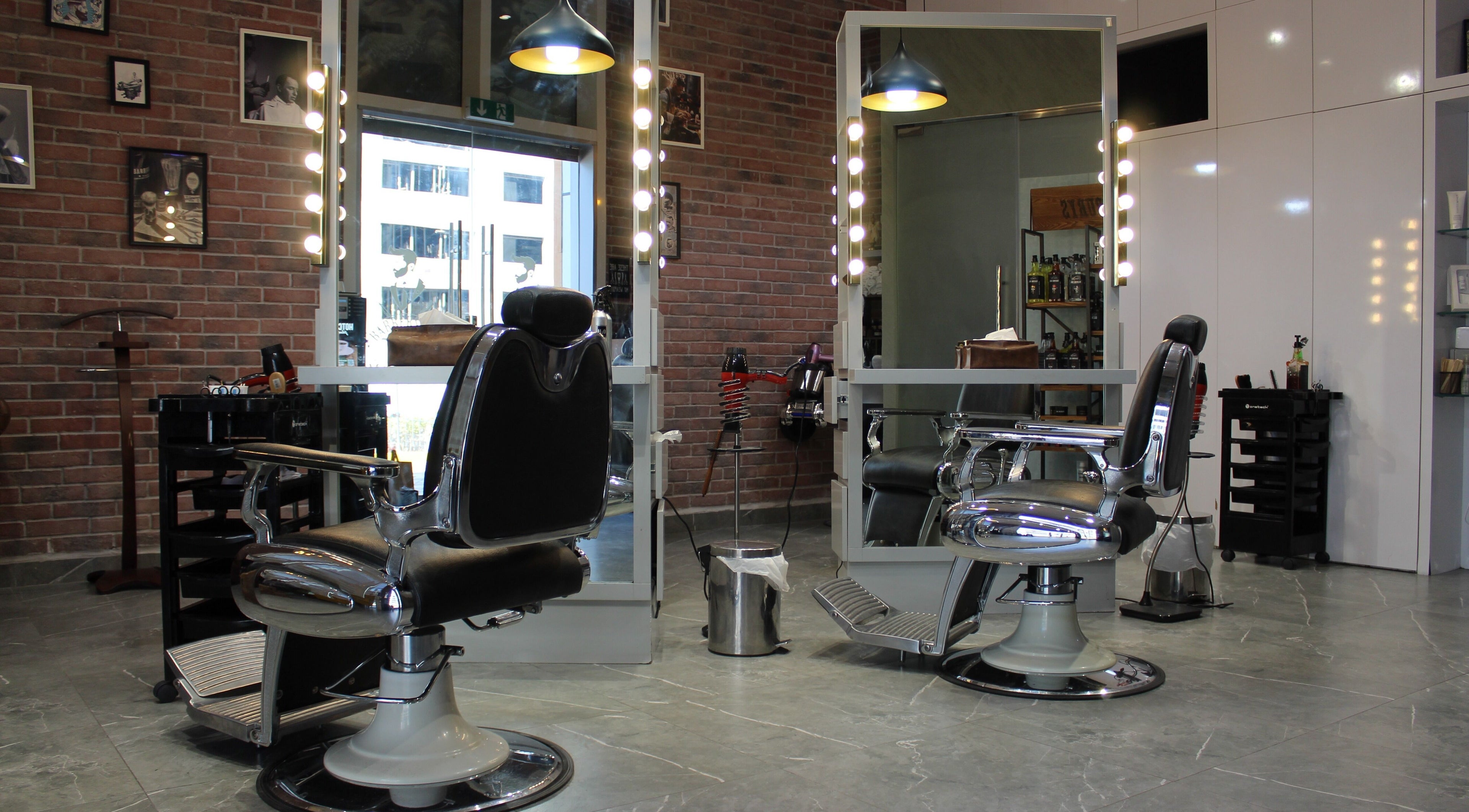 Interior view of Mankind Men Haircut - Gents Barbershop, Abu Dhabi, AE featuring vintage barber chairs.