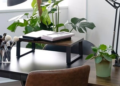 Elegant beauty workspace at EDDA Studio, Chipping Norton, England, GB with makeup brushes and greenery.