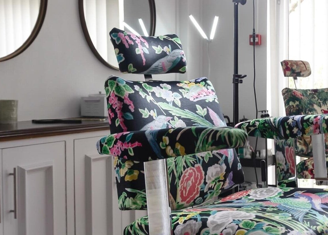 Floral-patterned salon chair at Atelier Yurga in Chipping Norton, England, GB, designed for comfort and style.