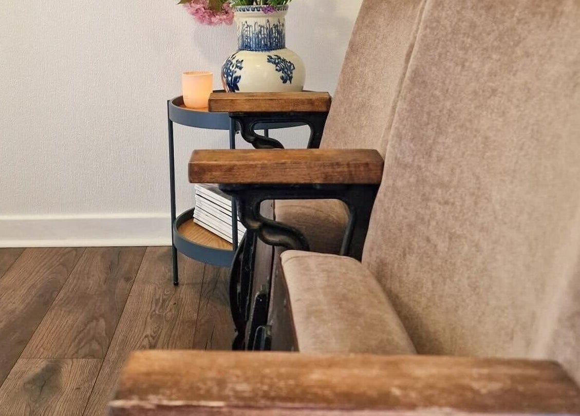 Plush seating with a vase and candle at Atelier Yurga, Chipping Norton, England, GB.
