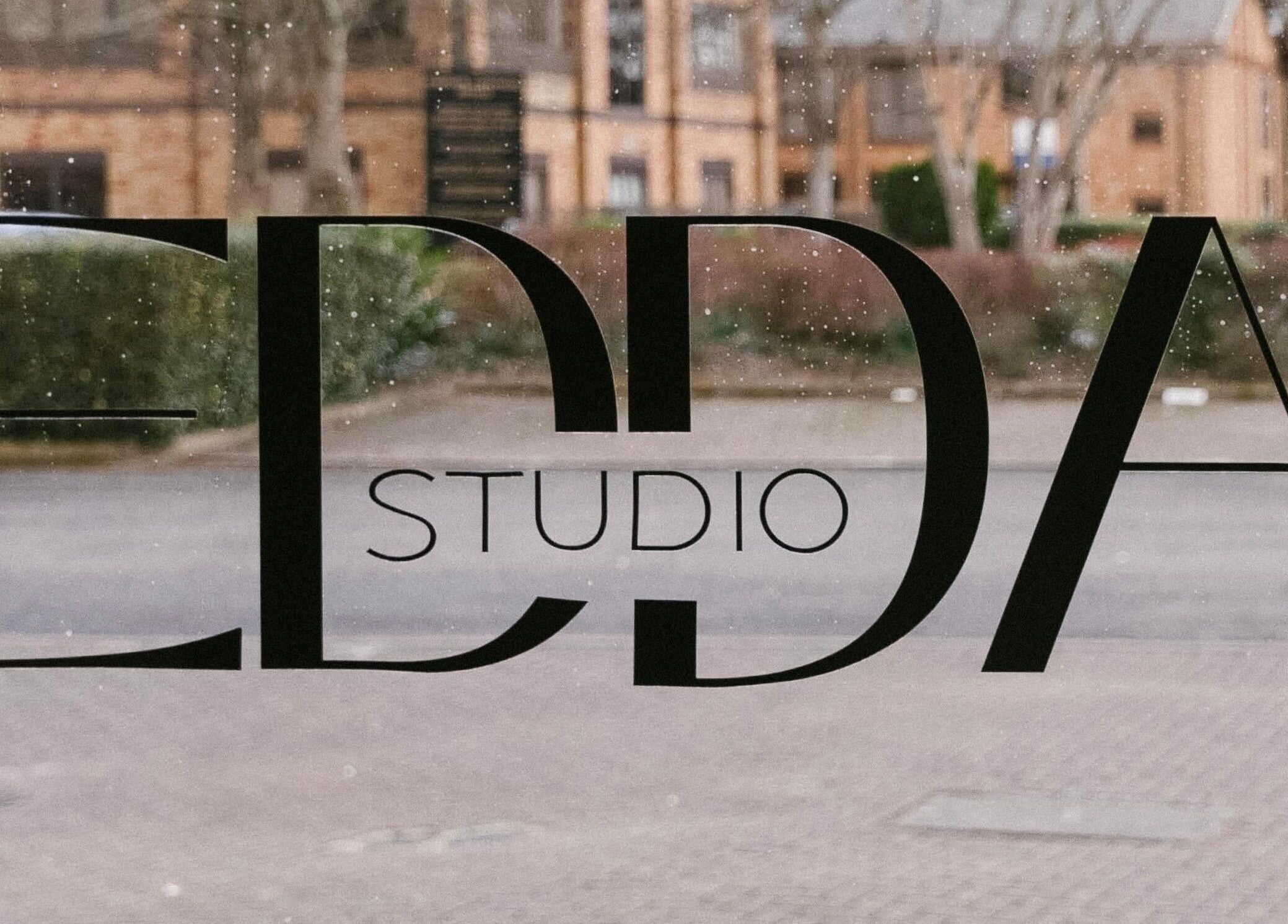 Stylish front window of Atelier Yurga in Chipping Norton, England, GB showcasing elegant studio sign.