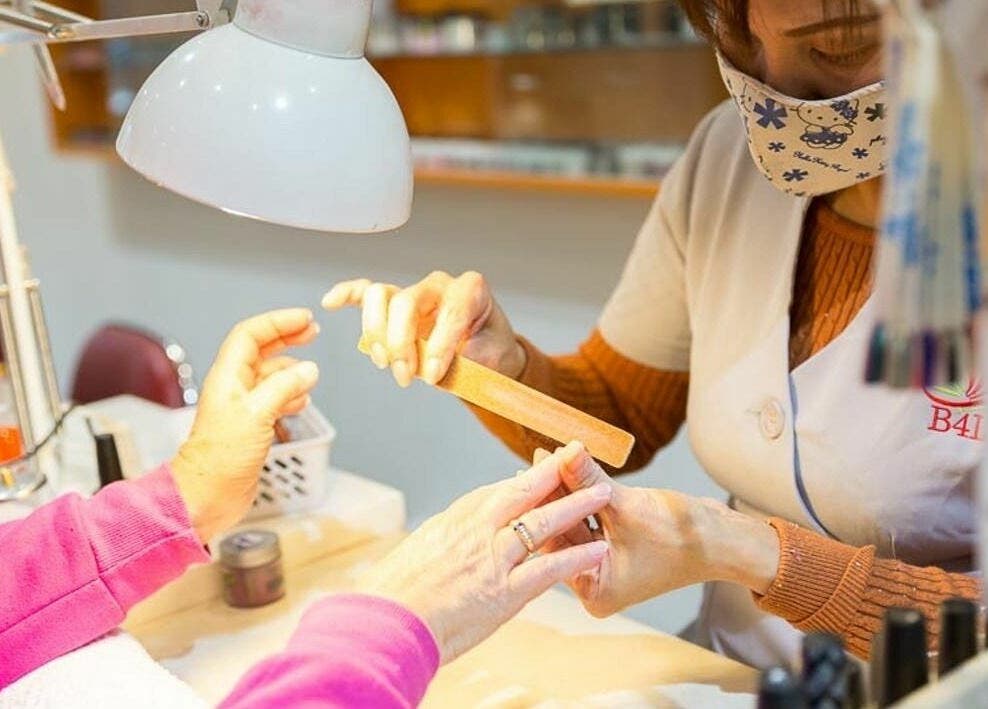 Nail technician at Beauty 4 Life Altona providing manicure service in Melbourne, Victoria, AU.