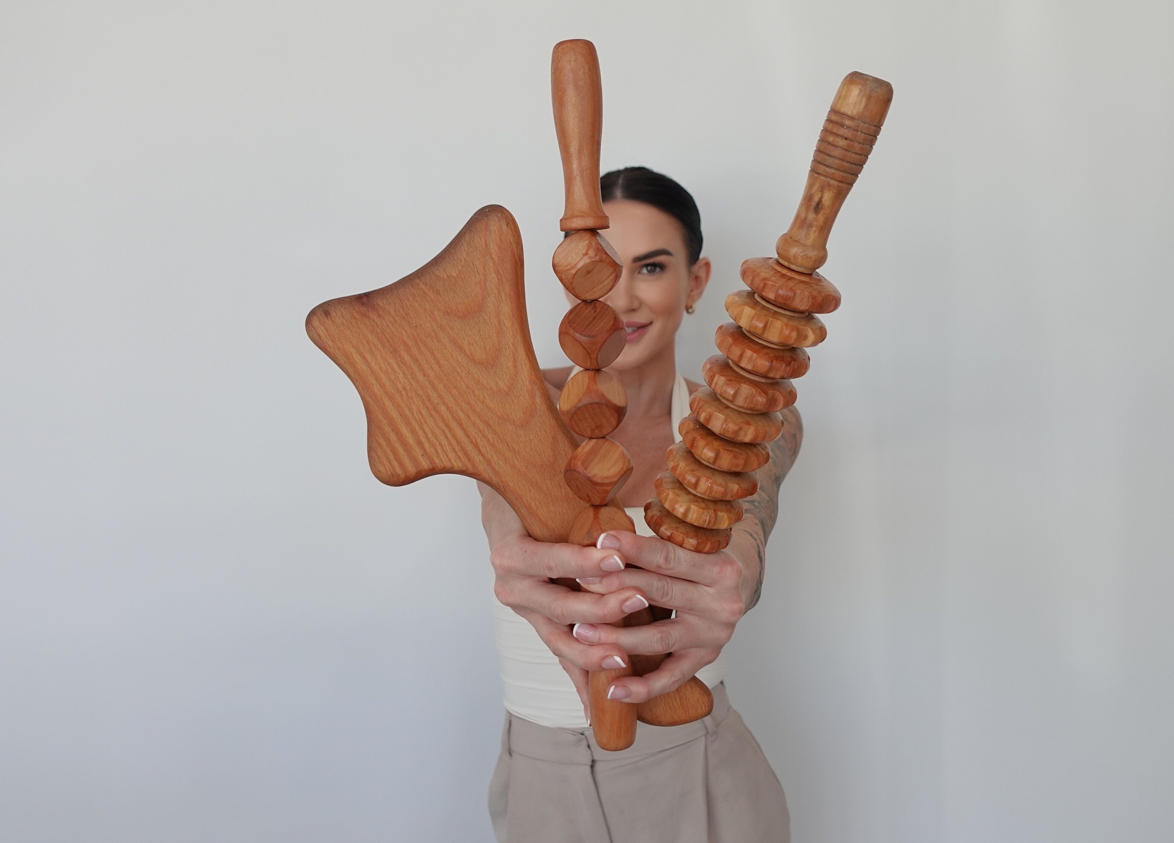 Person holding wooden massage tools at AMORE BODY LAB, Applecross, Western Australia, AU.