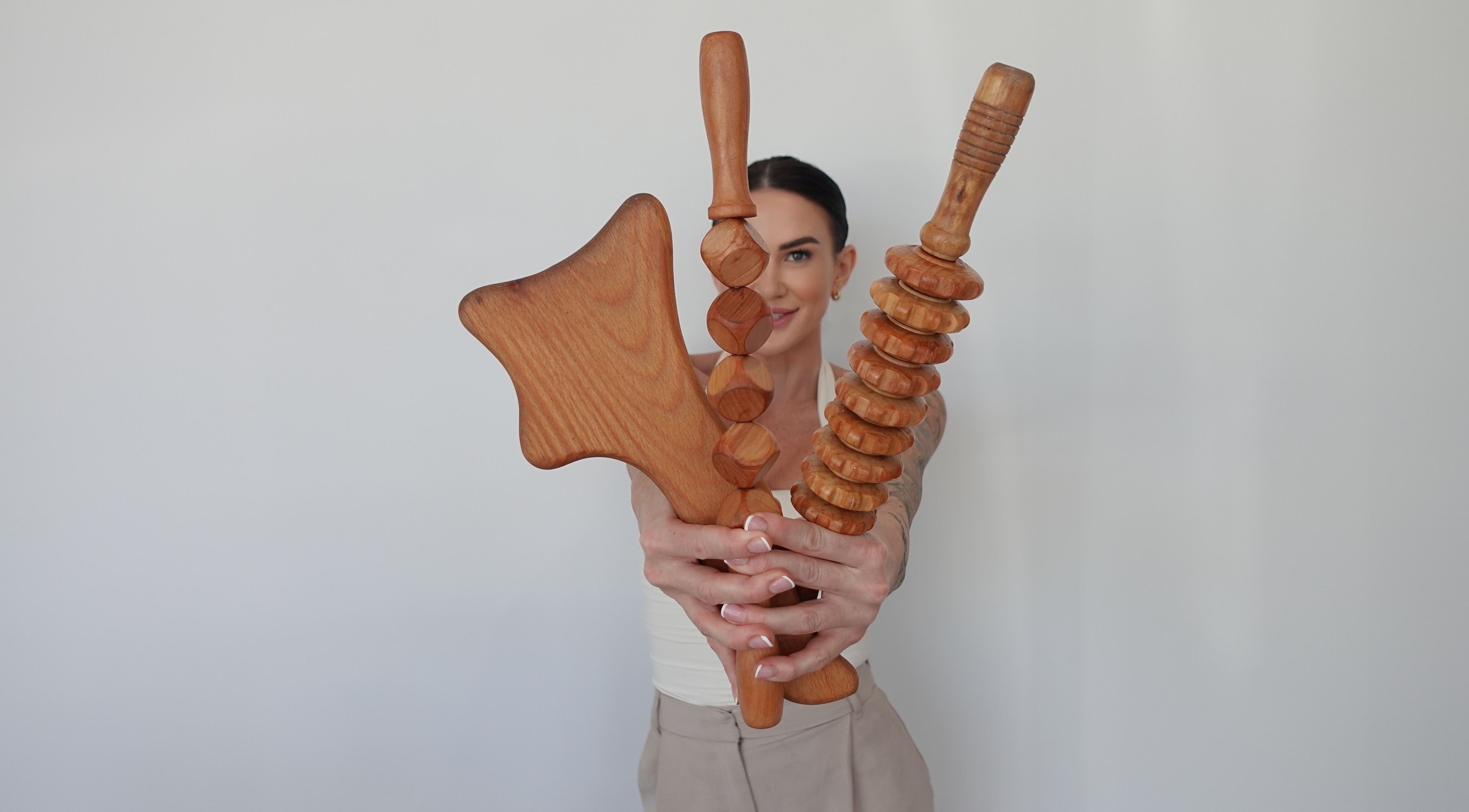Person holding wooden massage tools at AMORE BODY LAB, Applecross, Western Australia, AU.