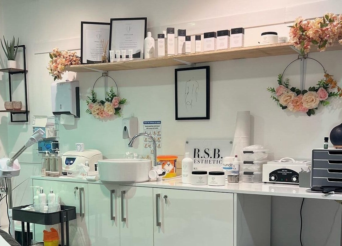 Beauty treatment station at RSB Aesthetics in Blackburn, England, GB with shelves, flowers, and skincare products.