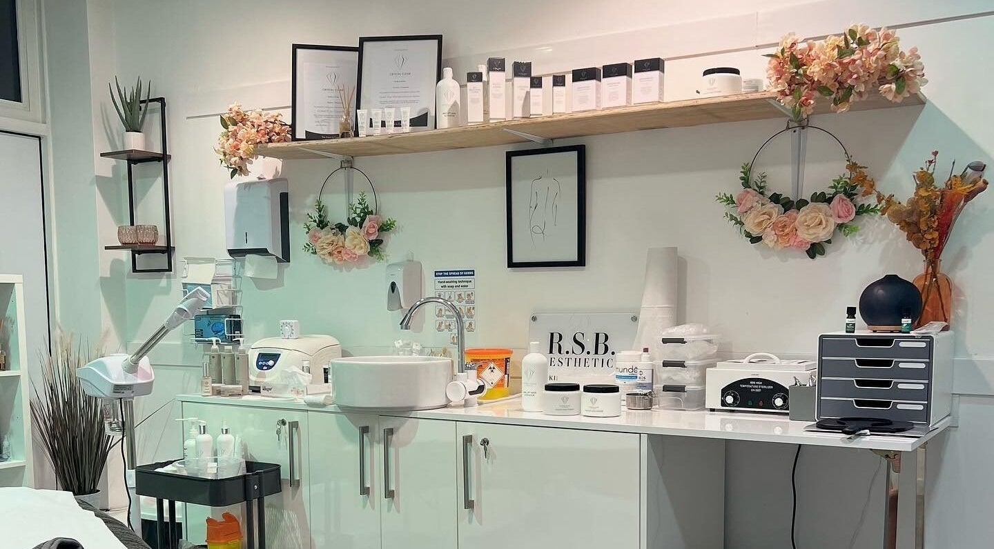 Beauty treatment station at RSB Aesthetics in Blackburn, England, GB with shelves, flowers, and skincare products.