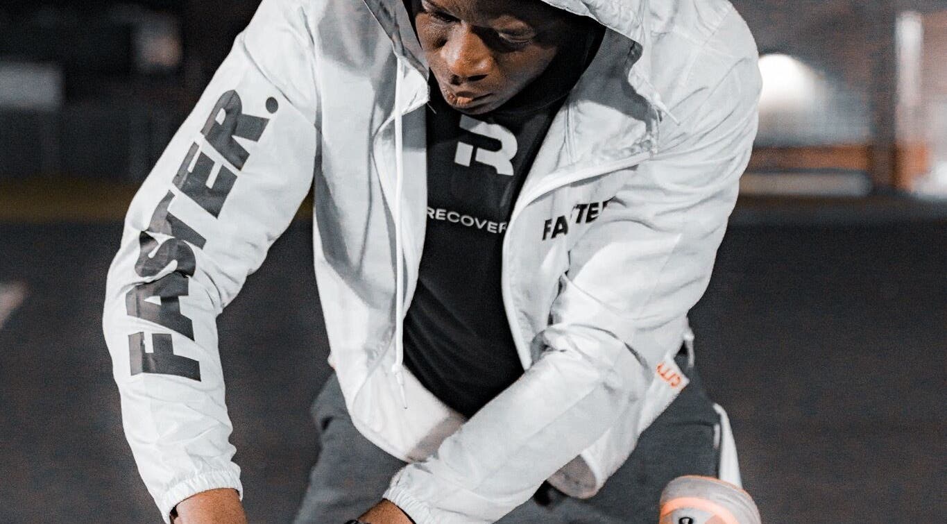 Focused athlete training outdoors in branded gear at Recover U Online (TeleHealth) in Houston, Texas, US.