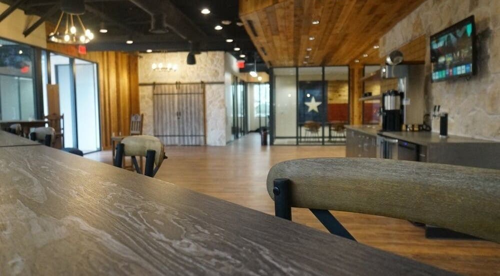 Stylish lounge area at MedXFit Houston, featuring wood accents and modern decor in Houston, Texas, US.