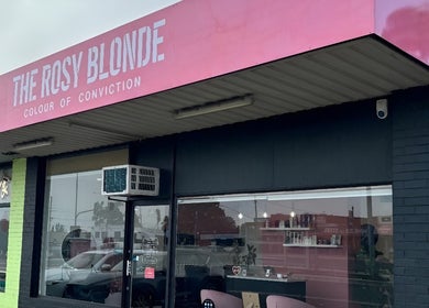 The Rosy Blonde salon exterior in Melbourne, Victoria, AU features a stylish pink sign.