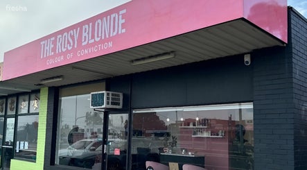 The Rosy Blonde salon exterior in Melbourne, Victoria, AU features a stylish pink sign.