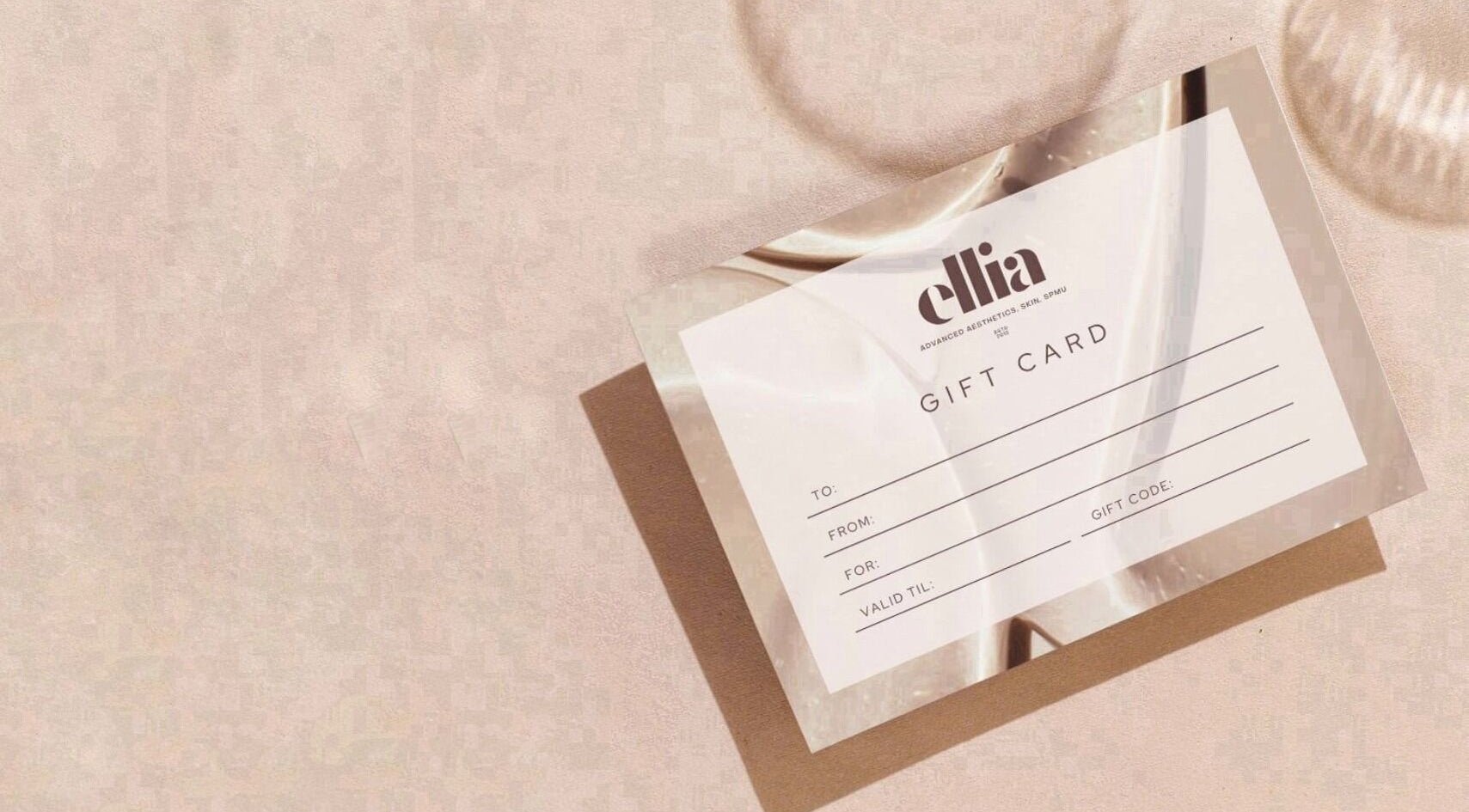 Ellia | Advanced Aesthetics, Skin, SPMU gift card on a beige surface, Orpington, England, GB.