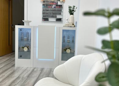 Chic reception area at Natalies Beauty & Training, Cardiff, Wales, GB featuring modern decor and product display.