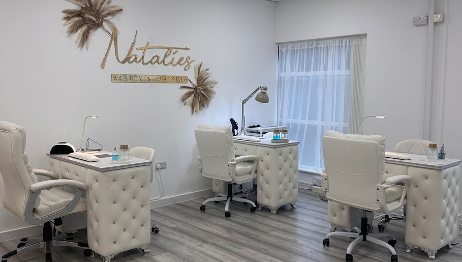 Elegant beauty desk setup at Natalies Beauty & Training, Cardiff, Wales, GB with plush chairs and decor.