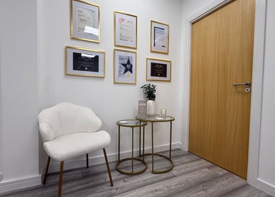 Modern waiting area at Natalies Beauty & Training, Cardiff, Wales, GB, with awards and cozy seating.