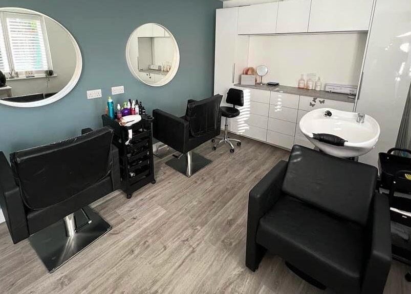 Modern styling room at Tresses Colour & Styling Room, Rochford, England, GB with chic mirrors and sleek chairs.