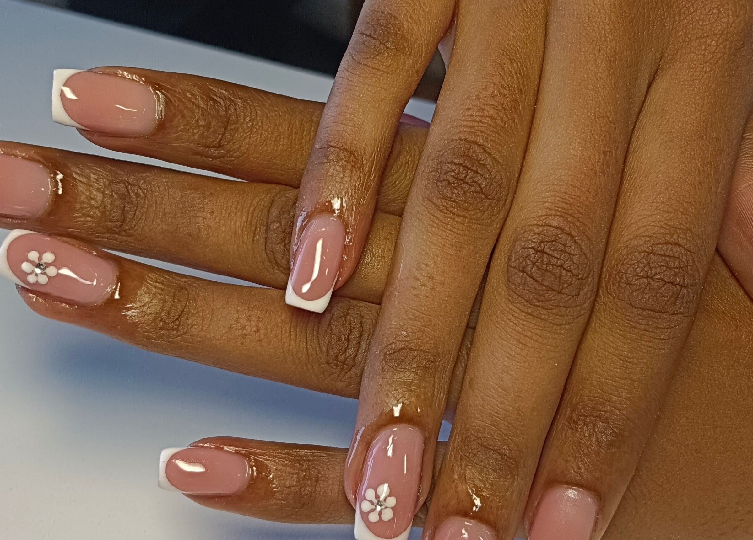 Elegant French manicure with floral design at Scarletgold Beauty Salon, Johannesburg, Gauteng, ZA.