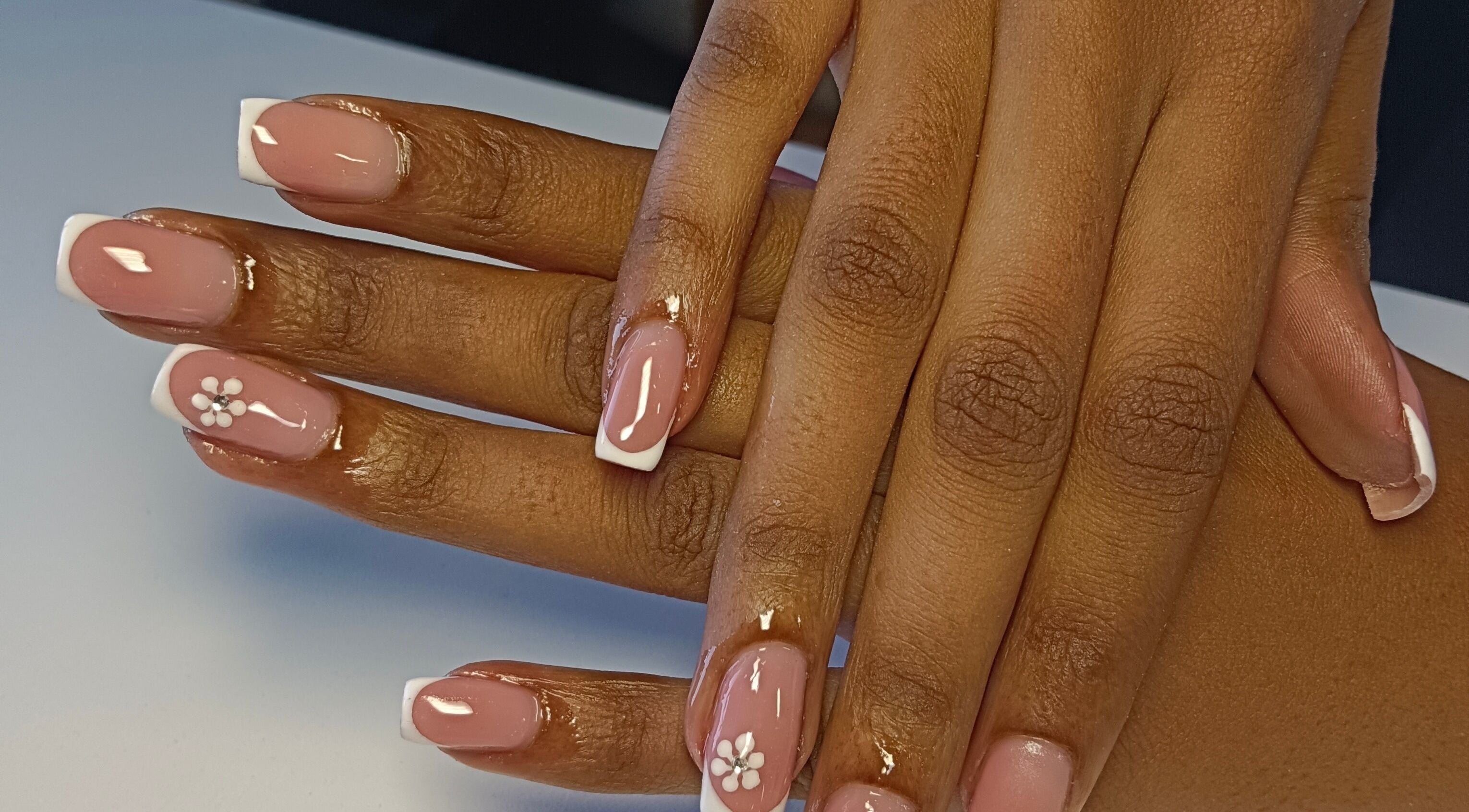 Elegant French manicure with floral design at Scarletgold Beauty Salon, Johannesburg, Gauteng, ZA.