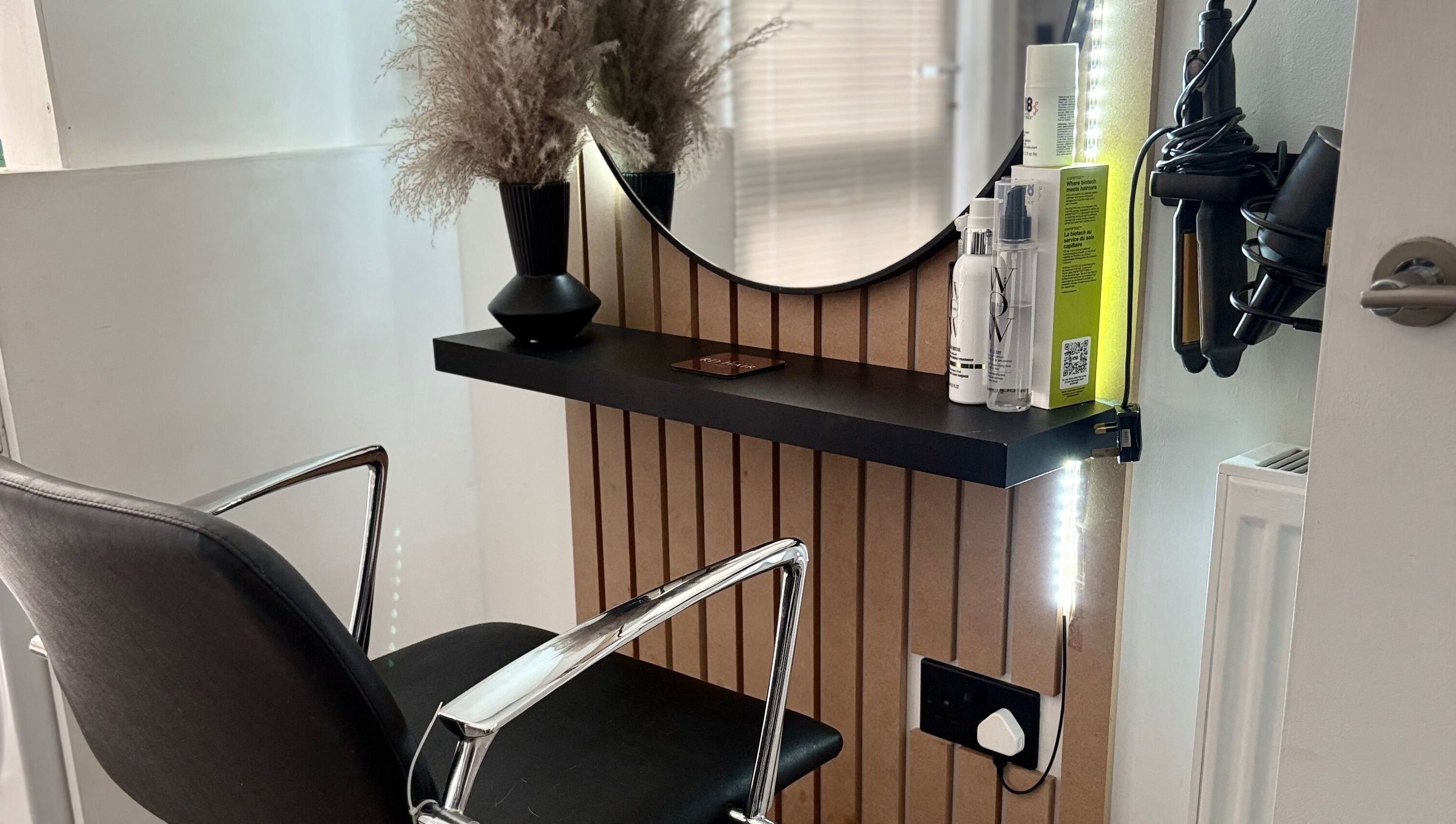 Sleek salon station at RD Hair in Ixworth, England with styling tools and decor.
