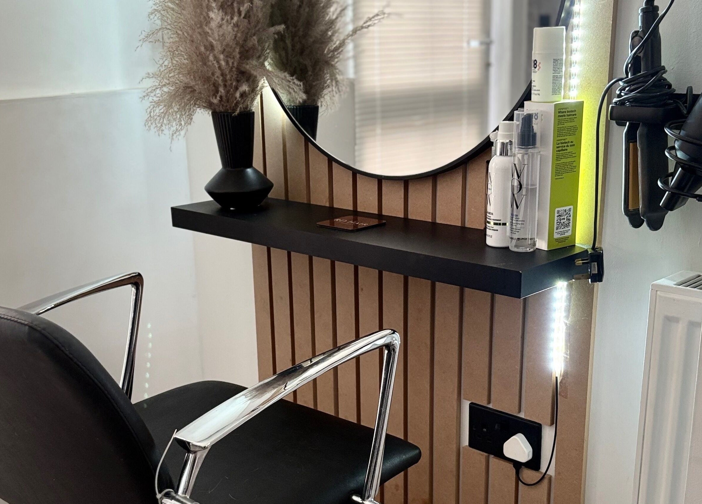Sleek salon station at RD Hair in Ixworth, England with styling tools and decor.