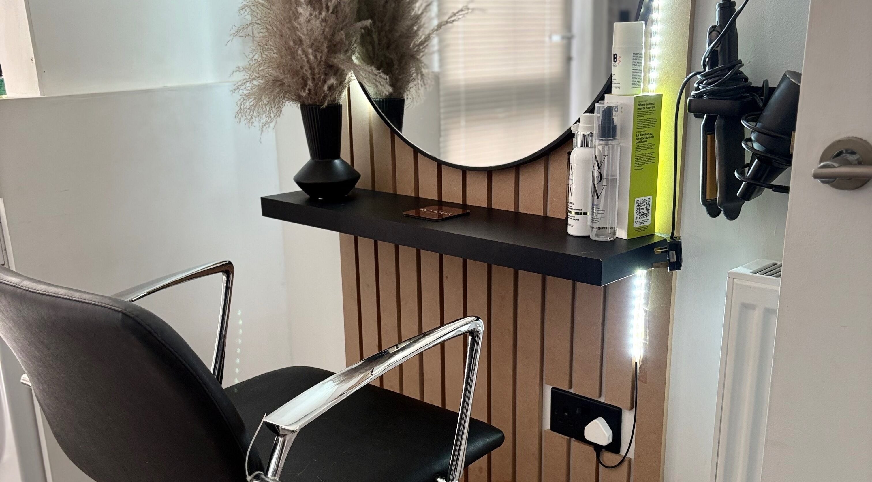 Sleek salon station at RD Hair in Ixworth, England with styling tools and decor.