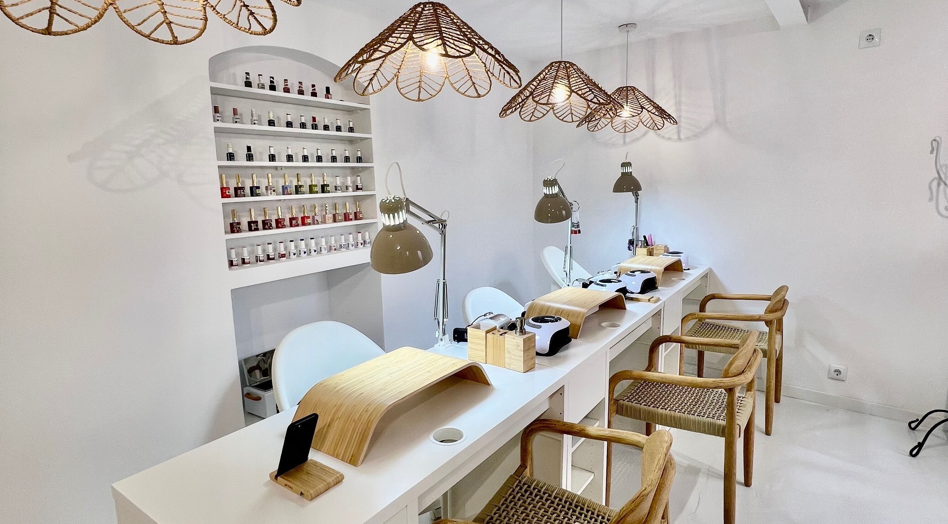 Bright nail salon interior at Bless Nails Lisbon, Lisboa, Lisboa, PT with manicure stations and polish display.