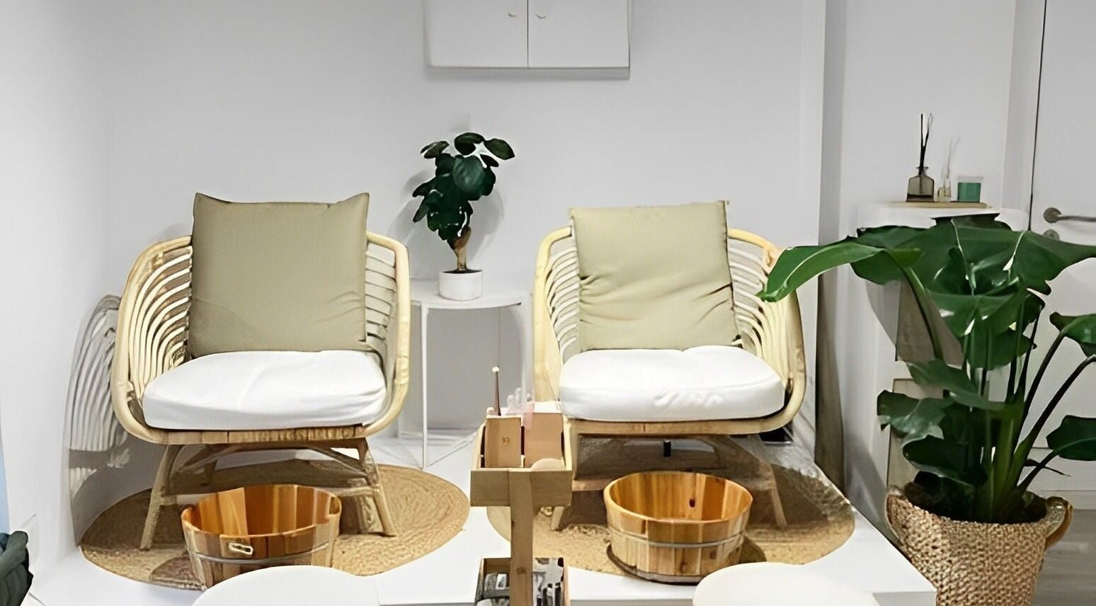 Tranquil pedicure chairs at Bless Nails Lisbon in Lisboa, Lisboa, PT surrounded by lush plants.