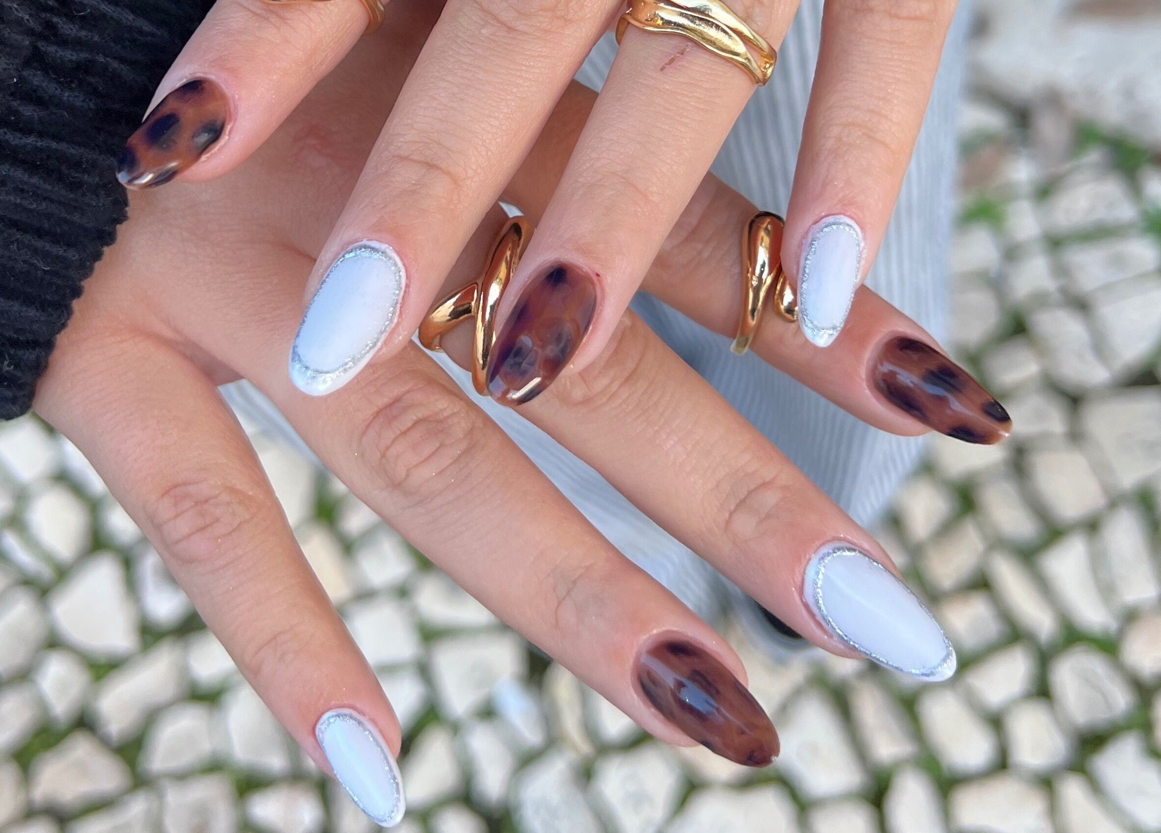 Stylish nail design at Bless Nails Lisbon in Lisboa, Lisboa, PT, featuring elegant blue and brown patterns.