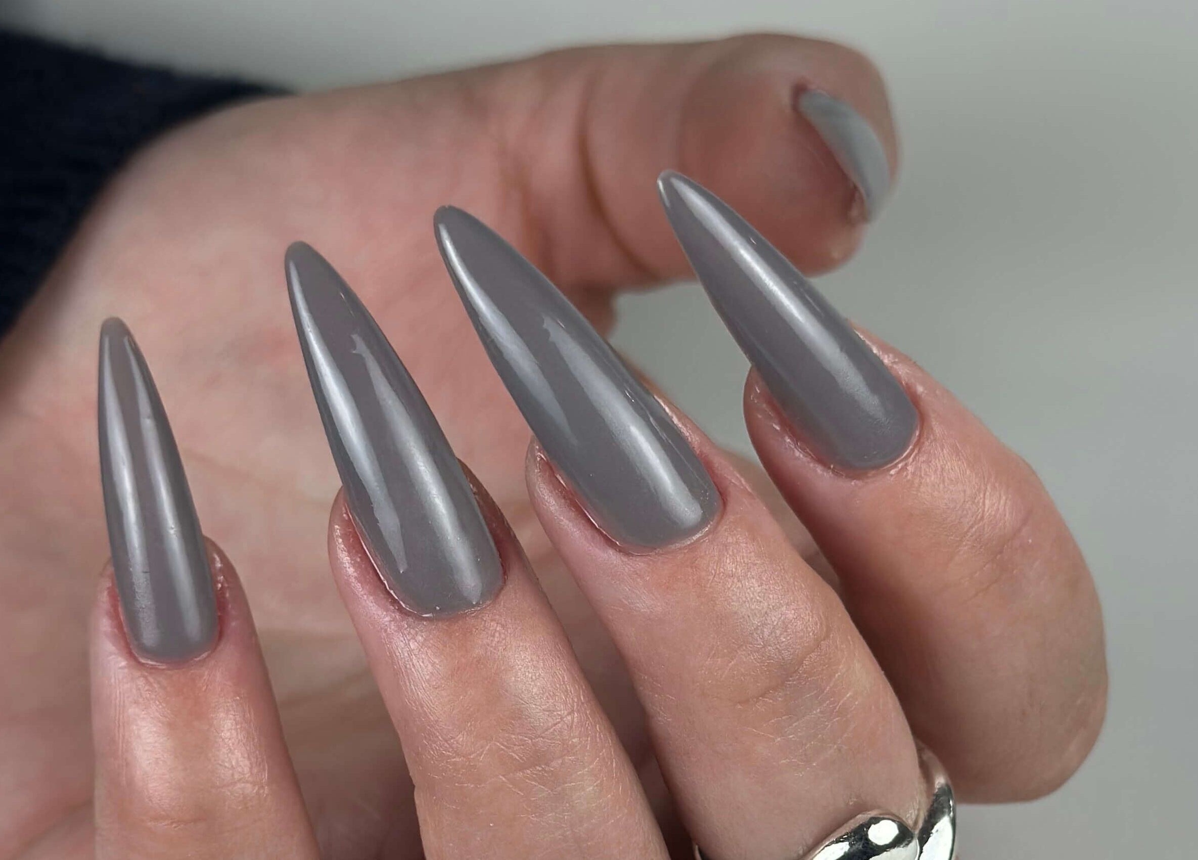 Elegant grey stiletto nails showcased at Bless Nails Lisbon, Lisboa, Lisboa, PT.
