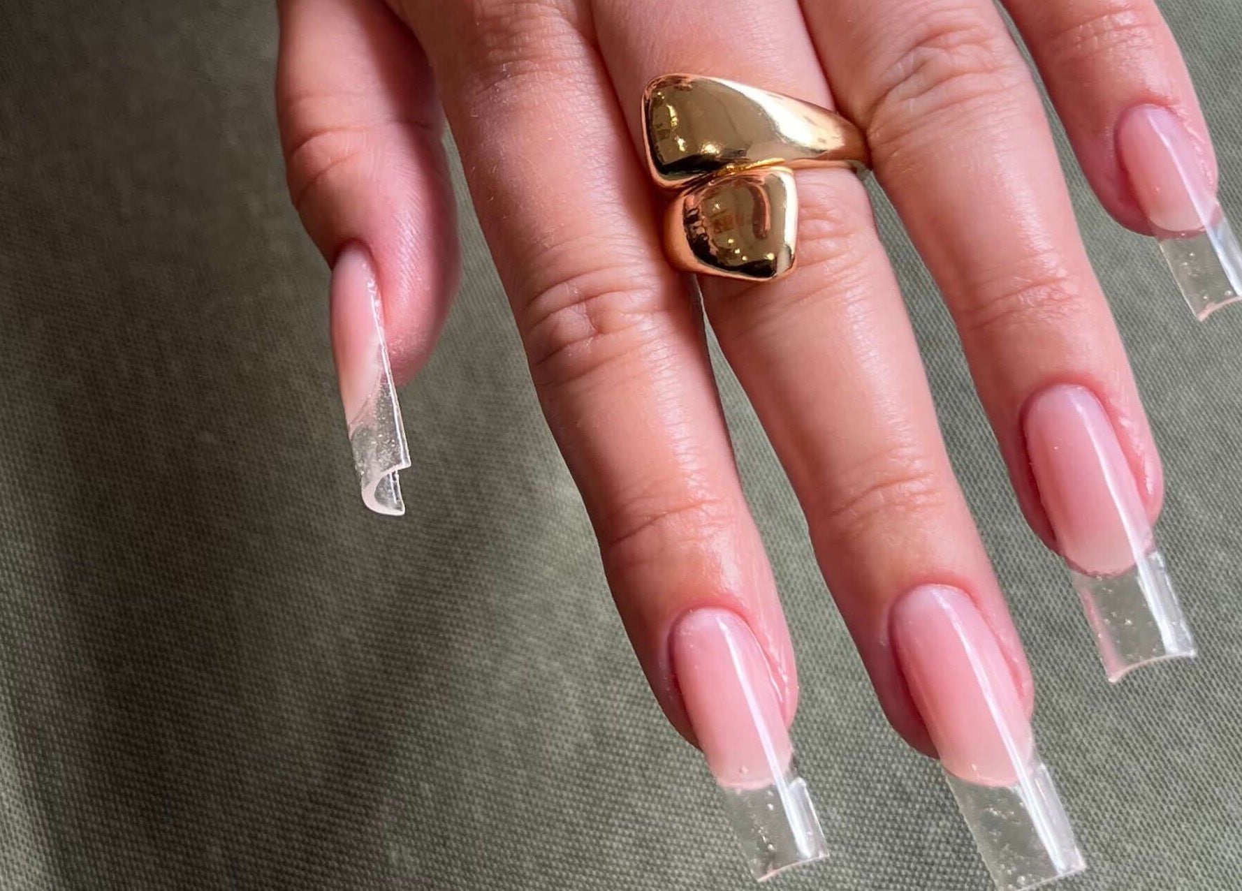 Sleek, nude manicured nails with a gold ring at Bless Nails Lisbon, Lisboa, Lisboa, PT.