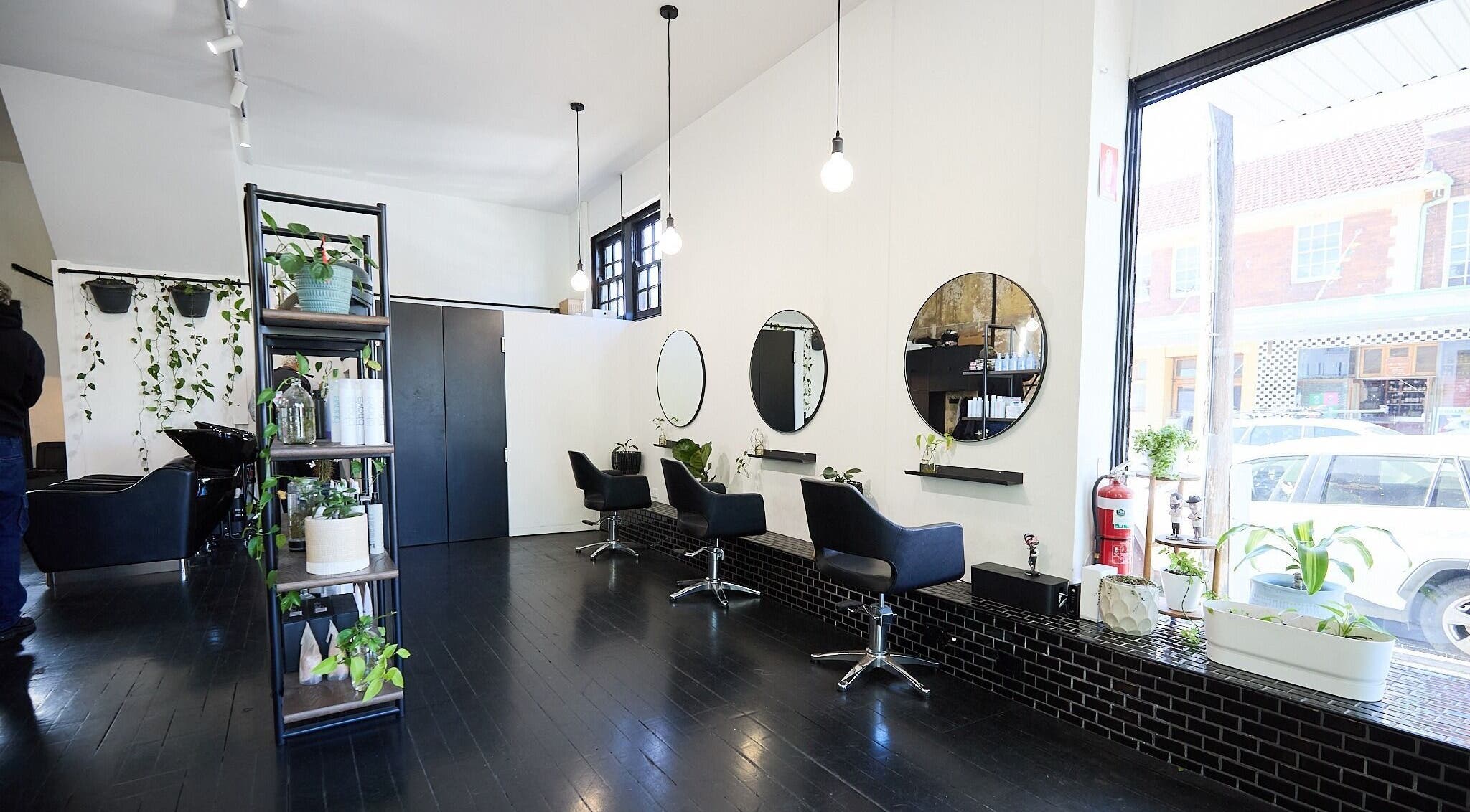 Interior of Blockhead Salon, Bondi Junction, New South Wales, AU, featuring sleek styling chairs and modern mirrors.