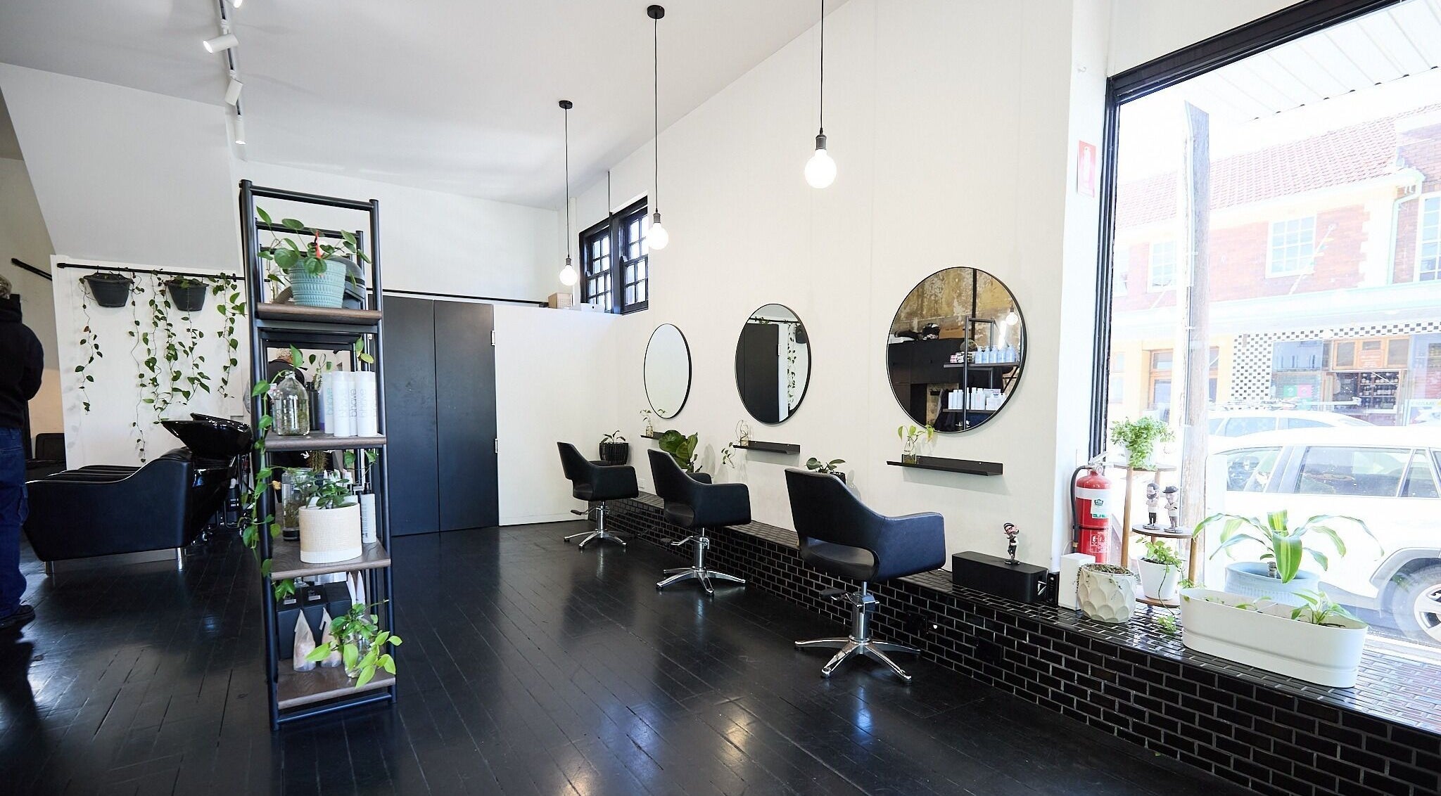 Interior of Blockhead Salon, Bondi Junction, New South Wales, AU, featuring sleek styling chairs and modern mirrors.