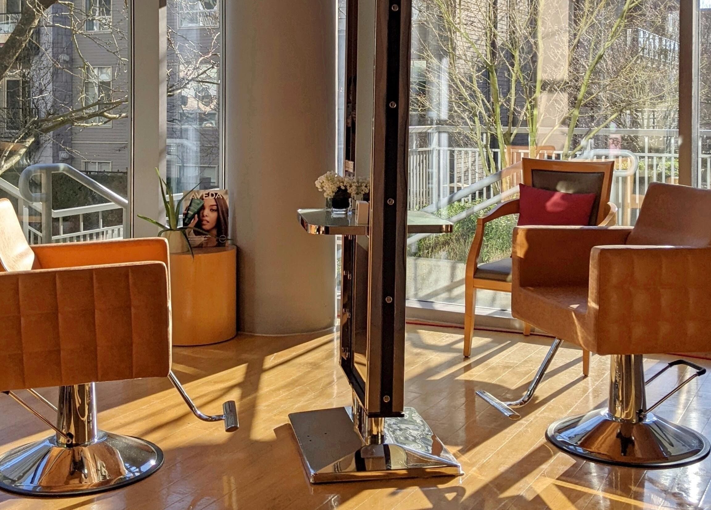 Stylish salon chairs in sunlight at E2 Salon Ubc, Vancouver, British Columbia, CA, enhancing a modern vibe.