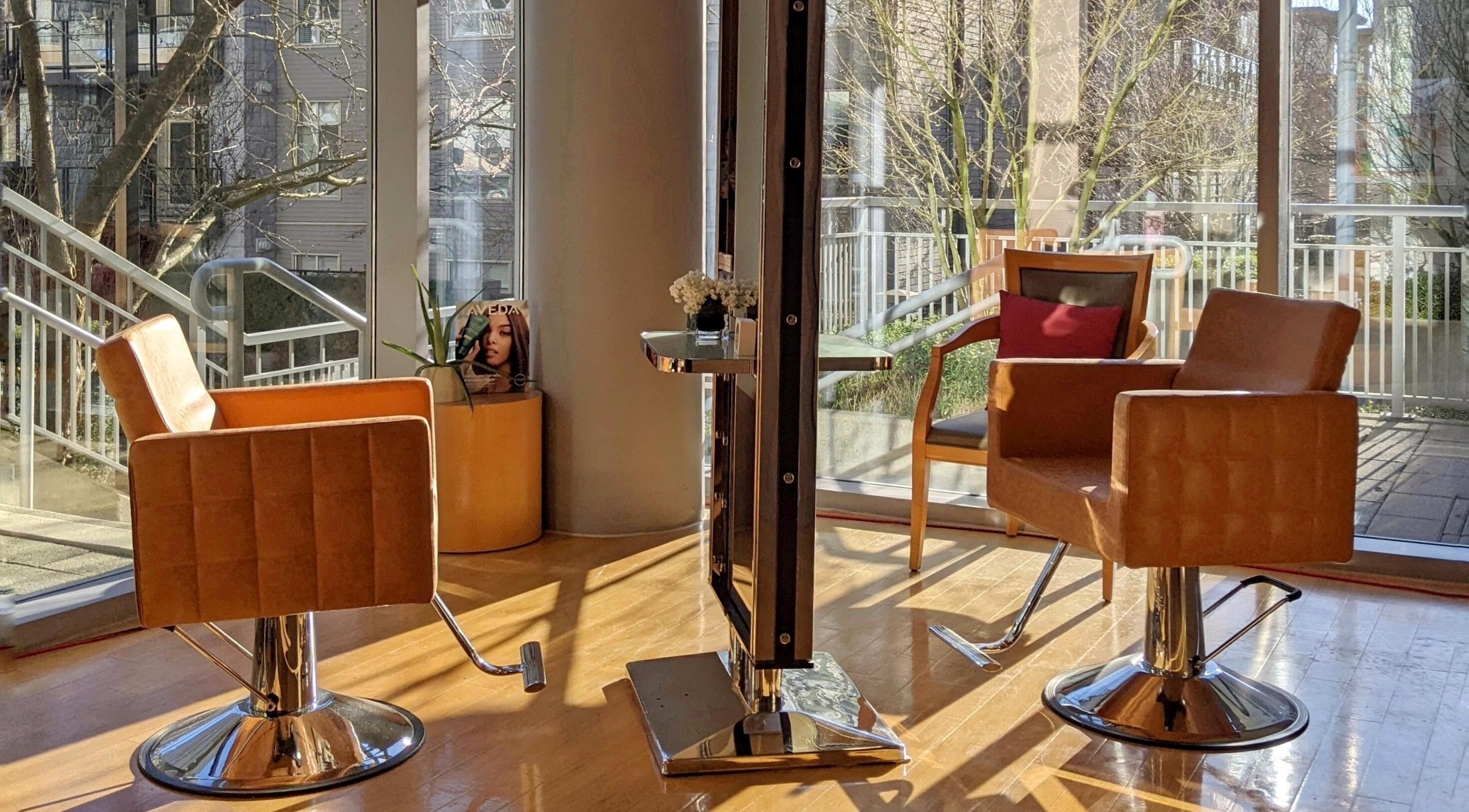 Stylish salon chairs in sunlight at E2 Salon Ubc, Vancouver, British Columbia, CA, enhancing a modern vibe.