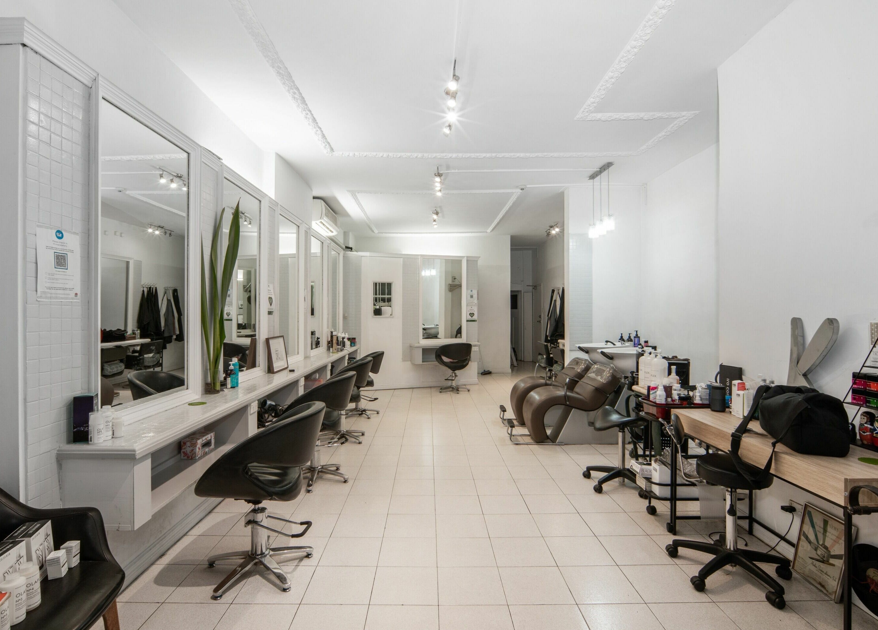 Spacious interior of Amore Salon, Potts Point, New South Wales, AU with sleek styling stations and modern decor.