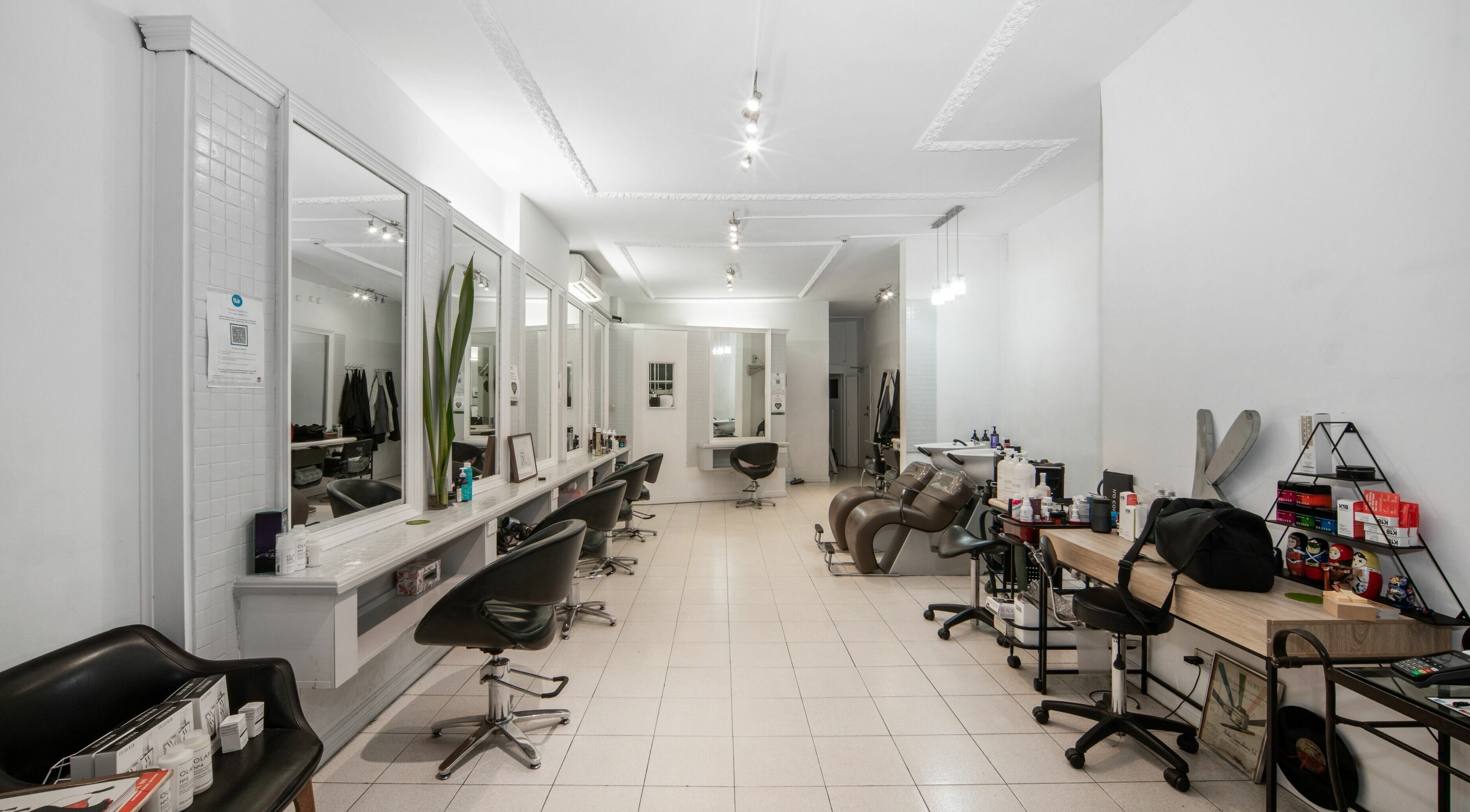 Spacious interior of Amore Salon, Potts Point, New South Wales, AU with sleek styling stations and modern decor.