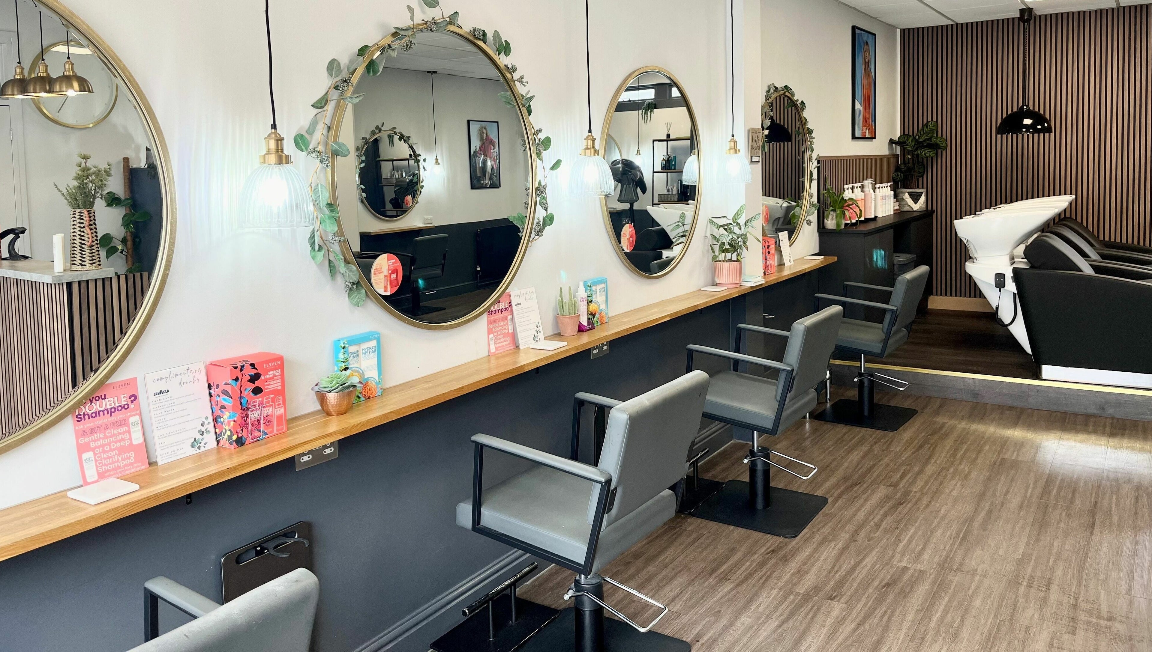 Modern salon interior at West One Hairdressing - West End, West End, England, showcasing chic design and mirrors.