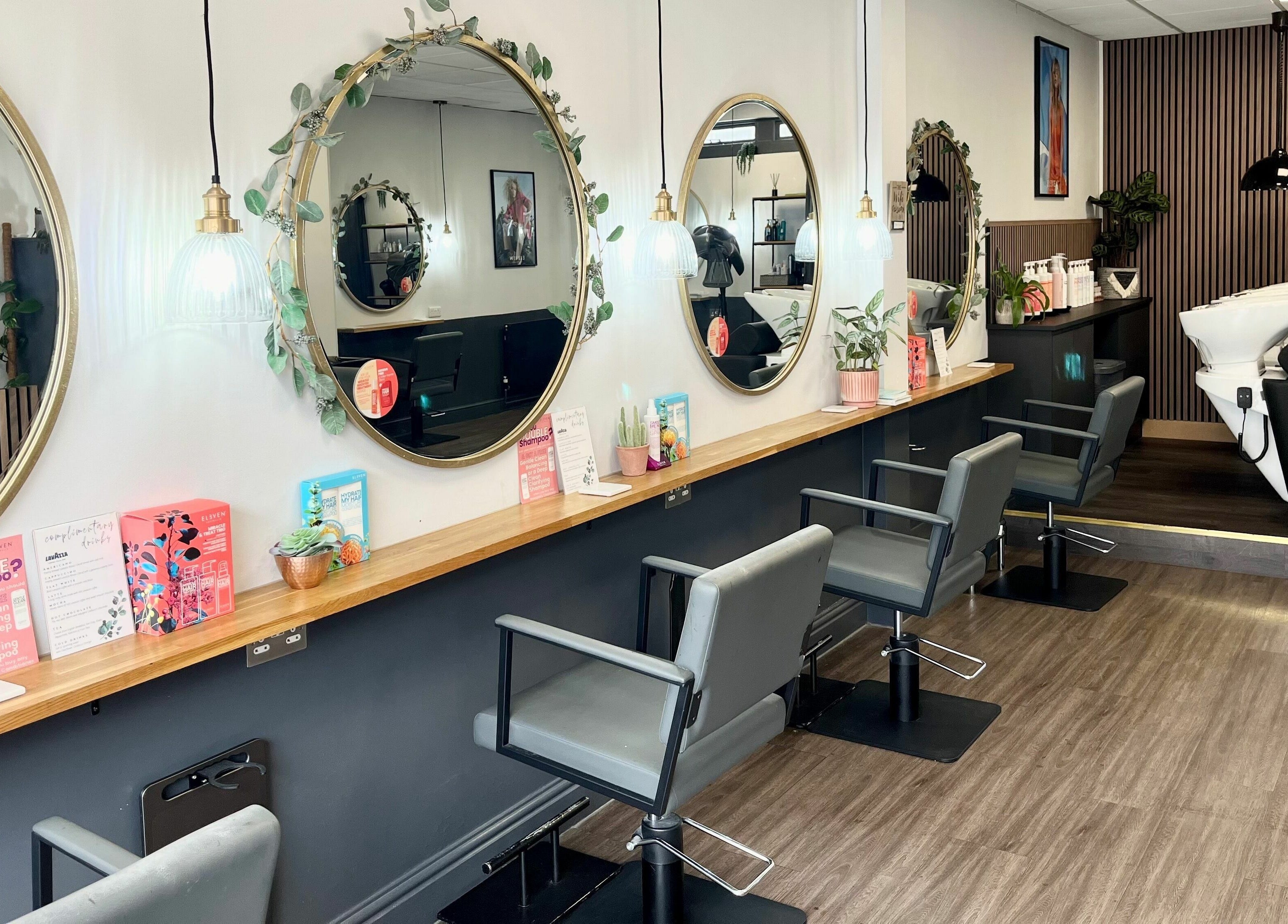 Modern salon interior at West One Hairdressing - West End, West End, England, showcasing chic design and mirrors.